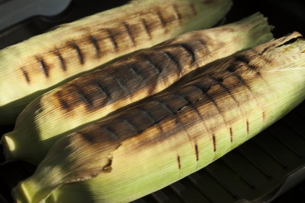 corn on the grill with husks on